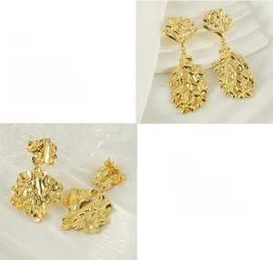 Detail view of 18K gold plated lava leaf earrings with polished and textured finishes