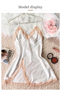 Close-up of silk slip nightgown with fine pink lace trim and delicate floral embroidery