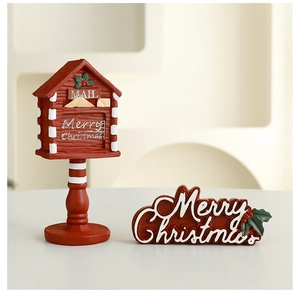 Festive red mailbox and Merry Christmas wooden plaque on a minimalist cream background