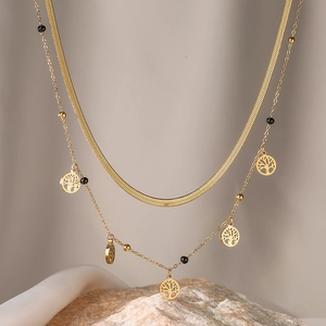 Double-layered gold tree of life necklace with flat snake chain and black bead accents