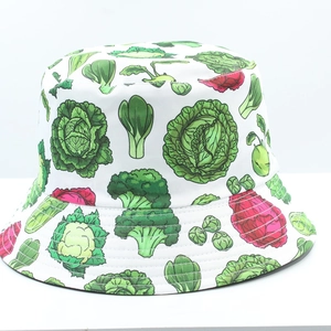 Detail of vibrant vegetable print featuring broccoli and cabbage on a white bucket hat