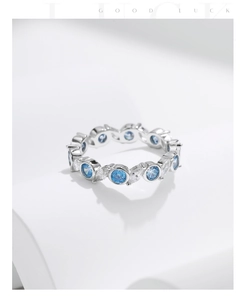 Close-up of S925 silver ring featuring blue round stones and clear marquise gems