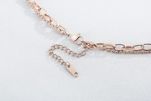 Detailed close-up of rose gold double layer necklace lobster clasp and extension chain