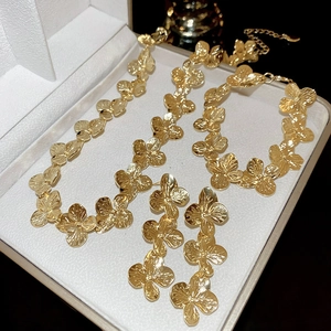 Golden flower jewelry set with necklace bracelet and earrings in a luxury white gift box
