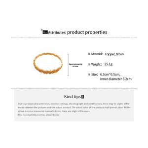 Detailed close-up of wavy gold-plated copper bracelet with sparkling zircon stones