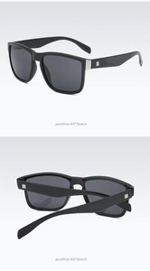 Detail view of black square sports sunglasses with silver metal hinge accents and sharp frames