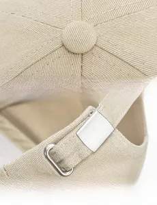 Detail of the metal adjustable buckle and precise stitching on the washed cotton baseball cap