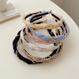 Five elegant woven headbands with pearls and gold chains in various soft colors