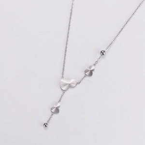 Detailed view of silver Y-shaped necklace with heart pendants and scalloped texture
