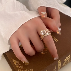 Macro detail of multi-layer gold stacked rings with oval zircon and pavé setting