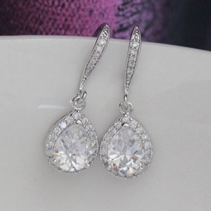 Macro shot of silver pear-shaped drop earrings featuring sparkling cubic zirconia stones