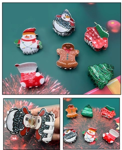 Macro detail of acrylic Christmas claw clips featuring snowman and gingerbread man designs
