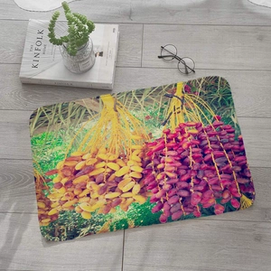 Detail view of fruit pattern flannel bath mat with vibrant date print on wooden floor