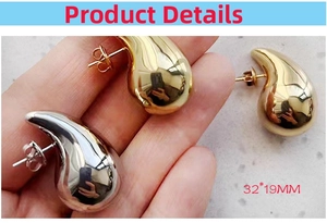 Close-up of teardrop earrings measuring 32x19mm in high-polish gold and silver finishes