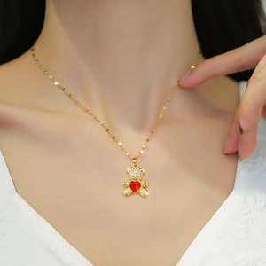 Detail of titanium steel bear necklace with red heart zircon pendant on a model