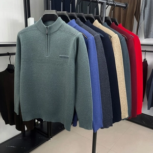 Detailed row of men's quarter-zip sweaters in various colors on hanging display