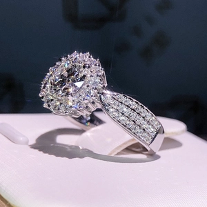 Luxury halo zircon engagement ring with multi-row pave band on a leather display