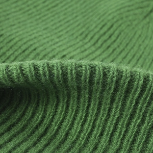 Thick warm wool knitted hat with ear protection in dark green ribbed textured knit