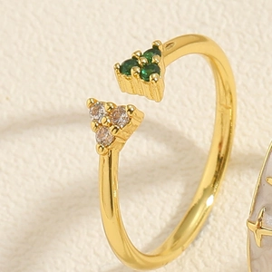 Detailed close-up of a gold adjustable ring featuring green and clear zircon stones