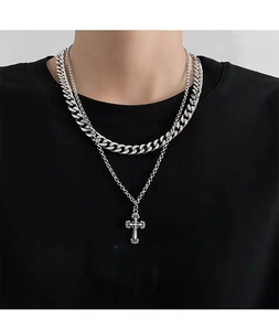 Detail of silver double-layered stainless steel Cuban chain necklace with cross pendant