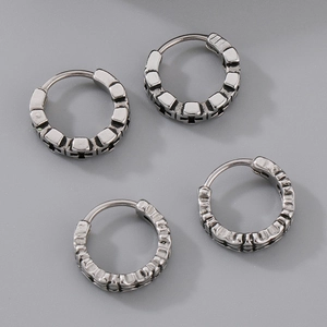 Detailed view of vintage silver steel hoop earrings with textured geometric patterns