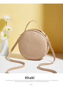 Detail of khaki round crossbody bag with V-pattern texture and gold zipper