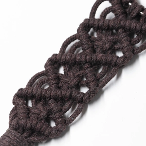 Macro shot of dark brown macrame woven cotton hat clip with detailed texture and knots