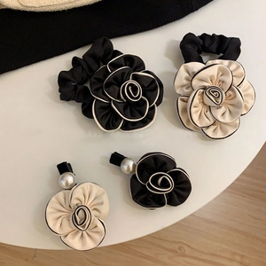 Elegant camellia hair scrunchies and pearl clips set in classic black and white style