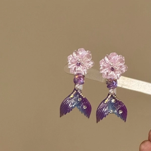Detailed close-up view of elegant purple mermaid tail hair clips with sparkling pearl flowers
