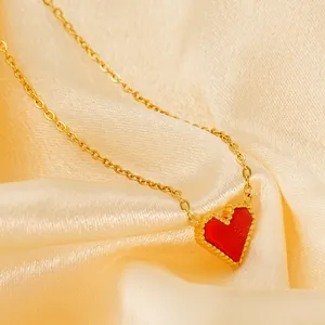 Minimalist 18k gold stainless steel heart pendant necklace on elegant satin background