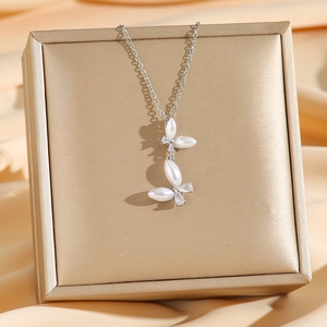 Silver necklace featuring double butterfly pendant with pearls and zircons on gold box