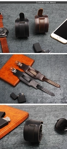 Detail of vintage leather watch band cuff with metallic buckle in black and brown