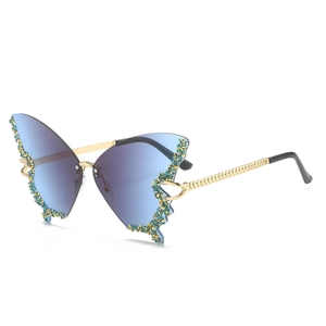 Detail of butterfly rimless sunglasses with blue gradient lenses and sparkling blue crystals