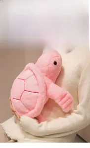 Detail of pink plush turtle with soft fabric texture and red shell stitching details
