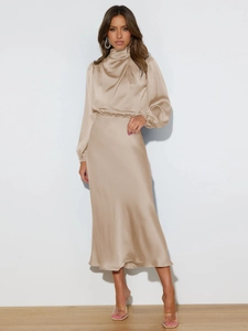 Detail of champagne gold satin evening dress showing high neck and pearl luster fabric