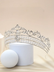 Macro detail of silver bridal crown with white pearls and sparkling crystal rhinestones