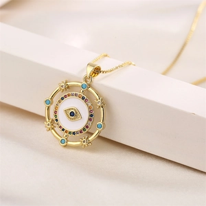 Macro shot of gold heart evil eye pendant necklace with colorful cubic zirconia stones