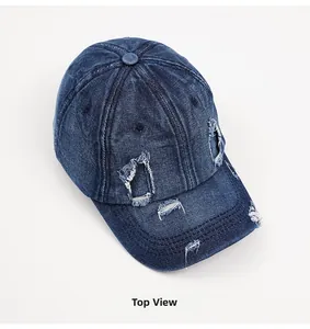 Top view of distressed blue denim baseball cap showing vintage ripped detailing and texture