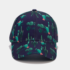 Detail of tropical cactus print on navy blue baseball cap with curved brim and stitching