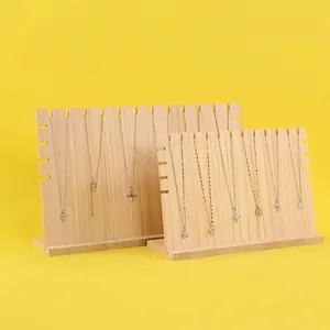 Solid wood necklace display stands set with multiple notches on a bright yellow background