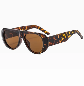 Detail of tortoise shell oval sunglasses showing integrated bridge and wide temples