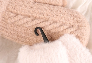Close-up of beige knitted gloves with soft faux fur cuffs and warm thermal lining