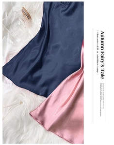 Detail of silk satin camisole nightdresses in navy and pink on white faux fur background