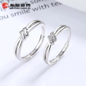 Close-up of S925 sterling silver Mobius rings with knot design and sparkling zircon inlays