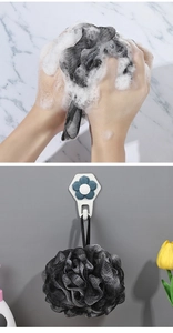 Detailed view of dual-tone charcoal bath sponge with rich foam and flower wall hook