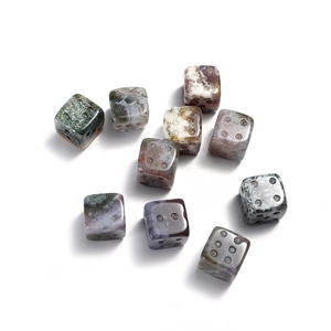 Group of ten natural crystal stone 15mm dice beads with engraved dots on white background
