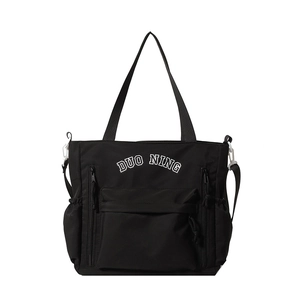 Large black nylon tote bag with multi-pocket design and adjustable shoulder strap
