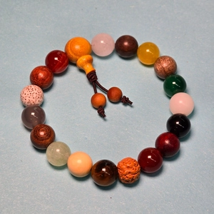 Detailed top view of 18 seeds Buddhist bracelet with multicolored wood and agate beads