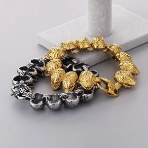 Detail of retro punk snake head clasps and scale links on gold and silver steel bracelets