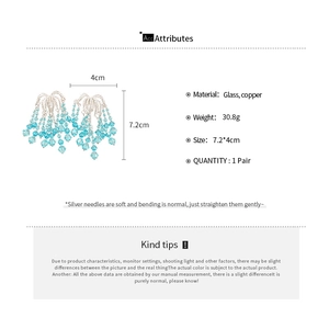 Detailed size and material specification of blue glass bead tassel earrings in copper